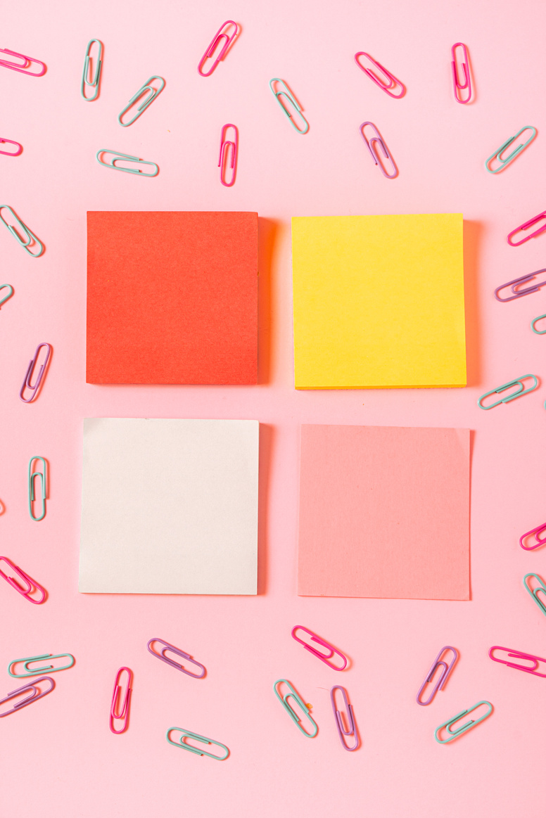 Yellow Orange White Post It on Pink Background